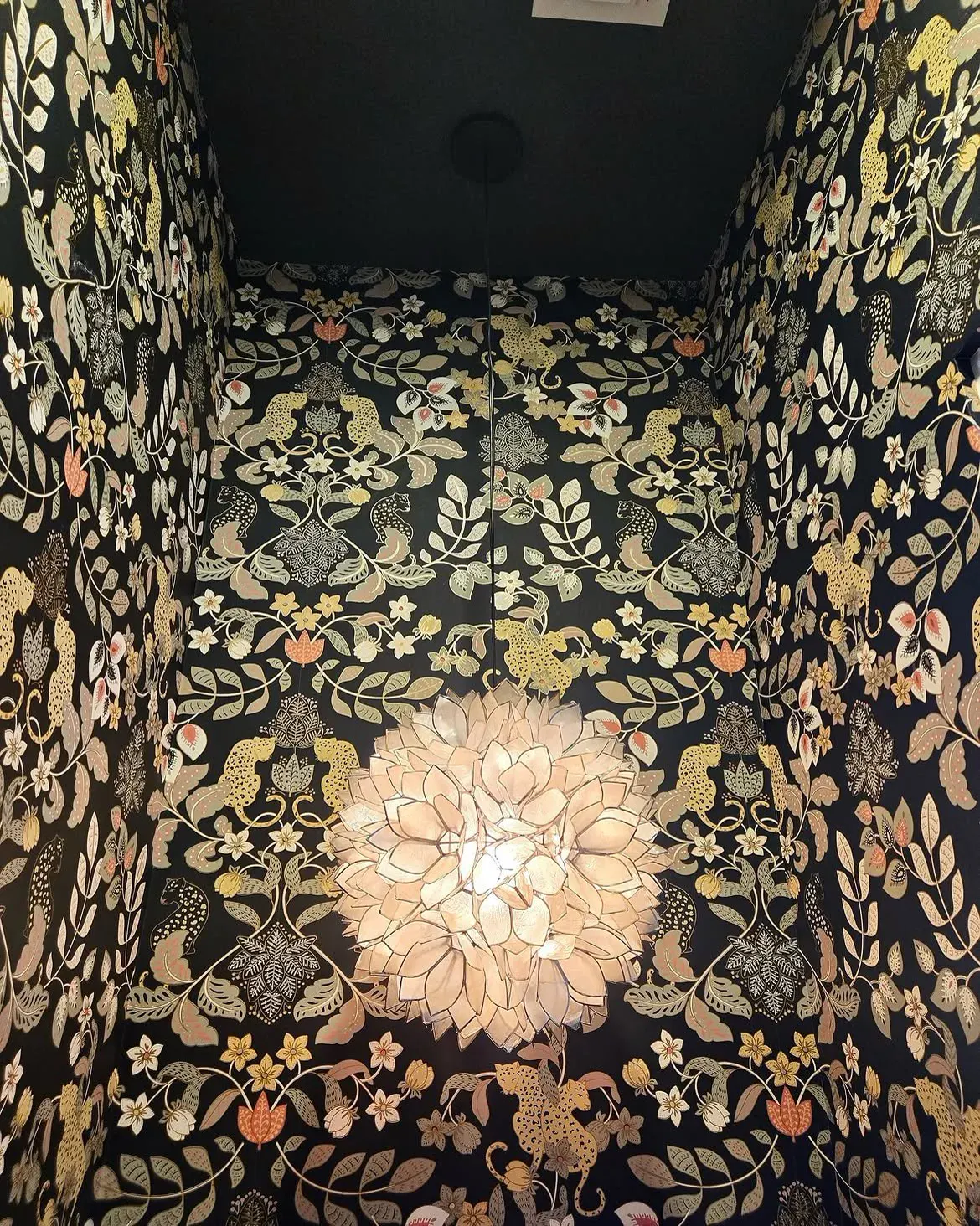Designer fixture paired with statement wallpaper